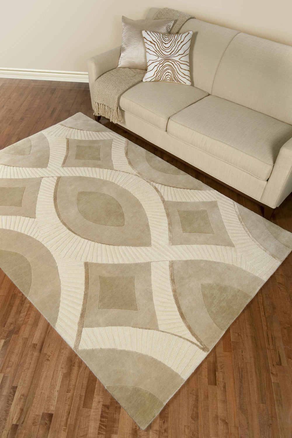 Ivory rectangular area rug with tan geometric shapes and layered stripe detailing
