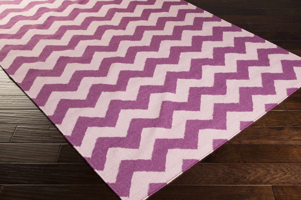 Hand-woven wool area rug, purple chevron zigzag pattern on angled corner