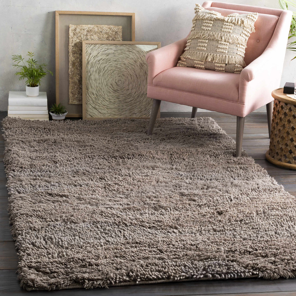 Taupe shag area rug with dense textured fibers and flat, even pile