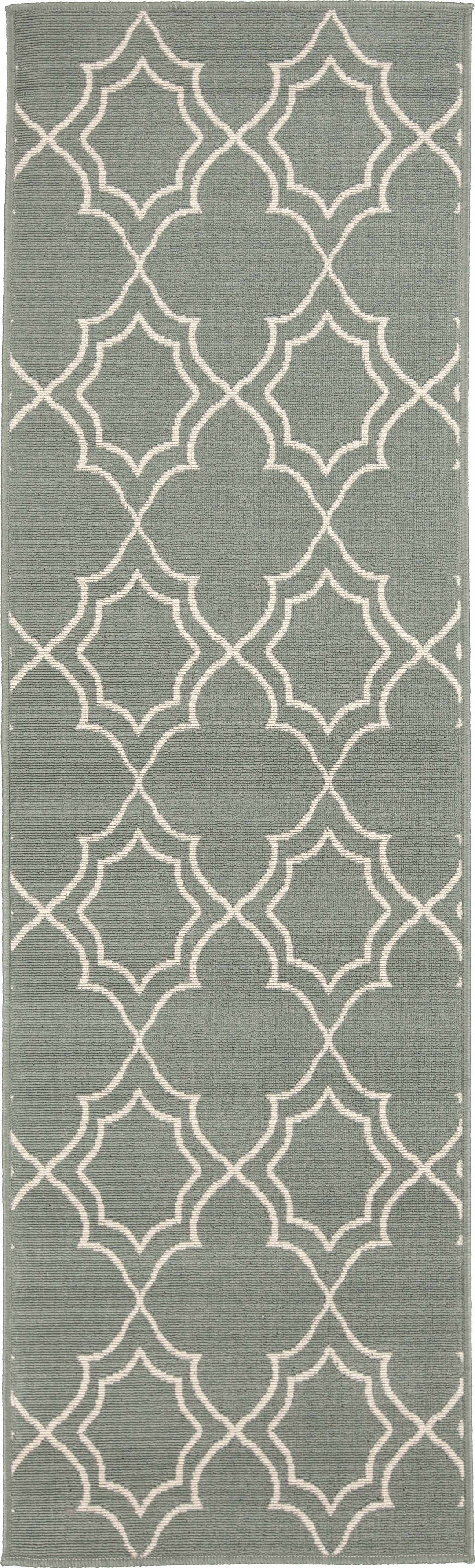 Runner-style green area rug with repeating beige trellis quatrefoil geometric pattern