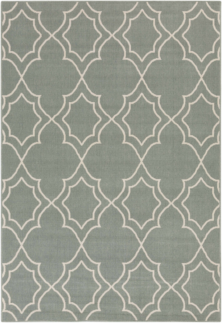 Green area rug with repeating beige trellis quatrefoil geometric pattern