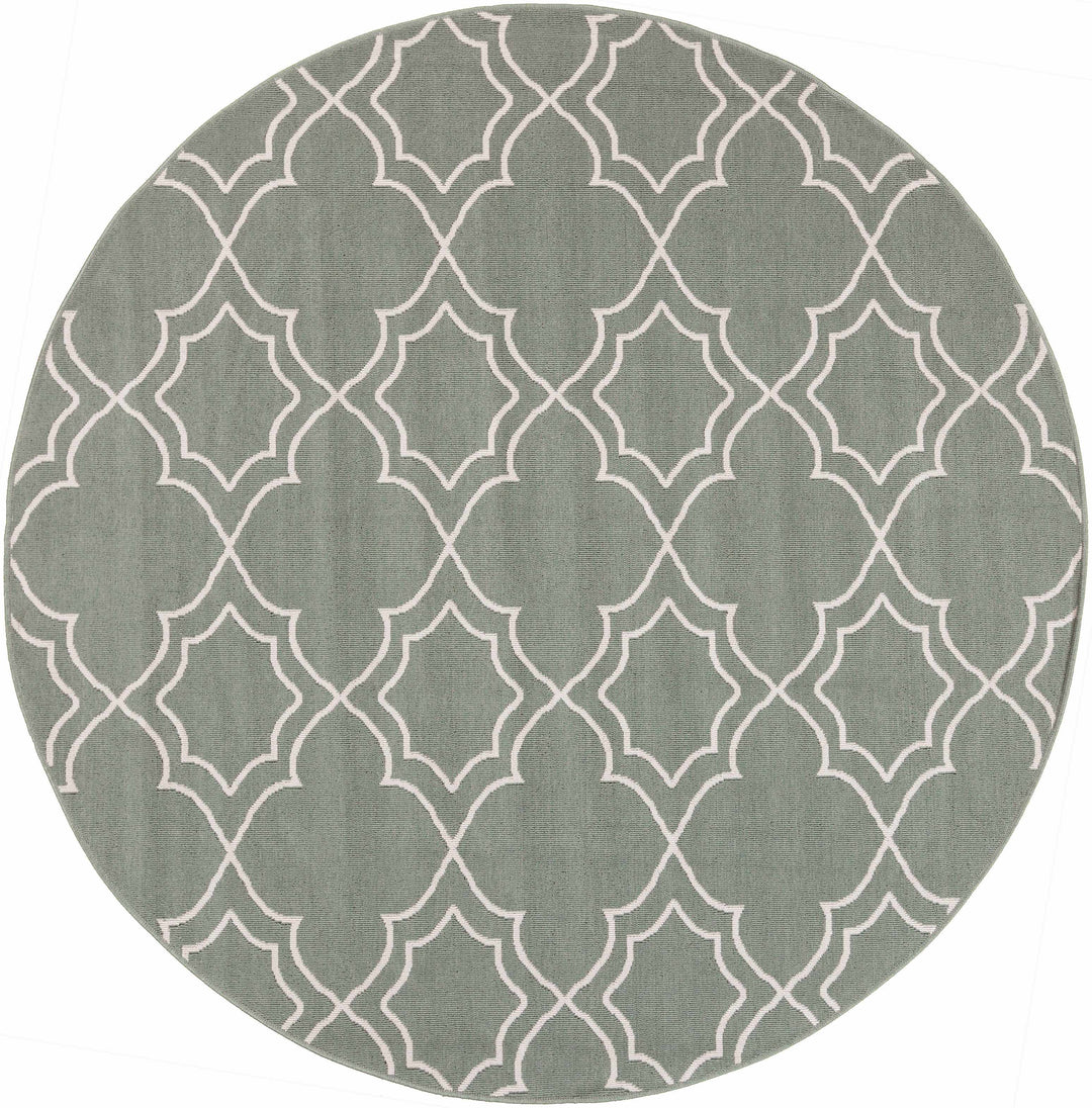 Round green area rug with beige trellis quatrefoil pattern and stitched border