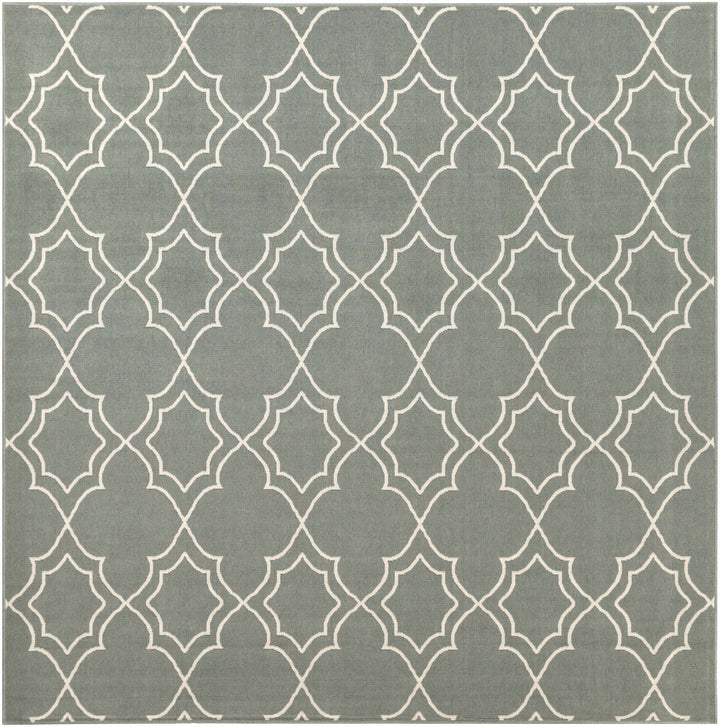 Large green area rug with repeating beige trellis quatrefoil geometric motif