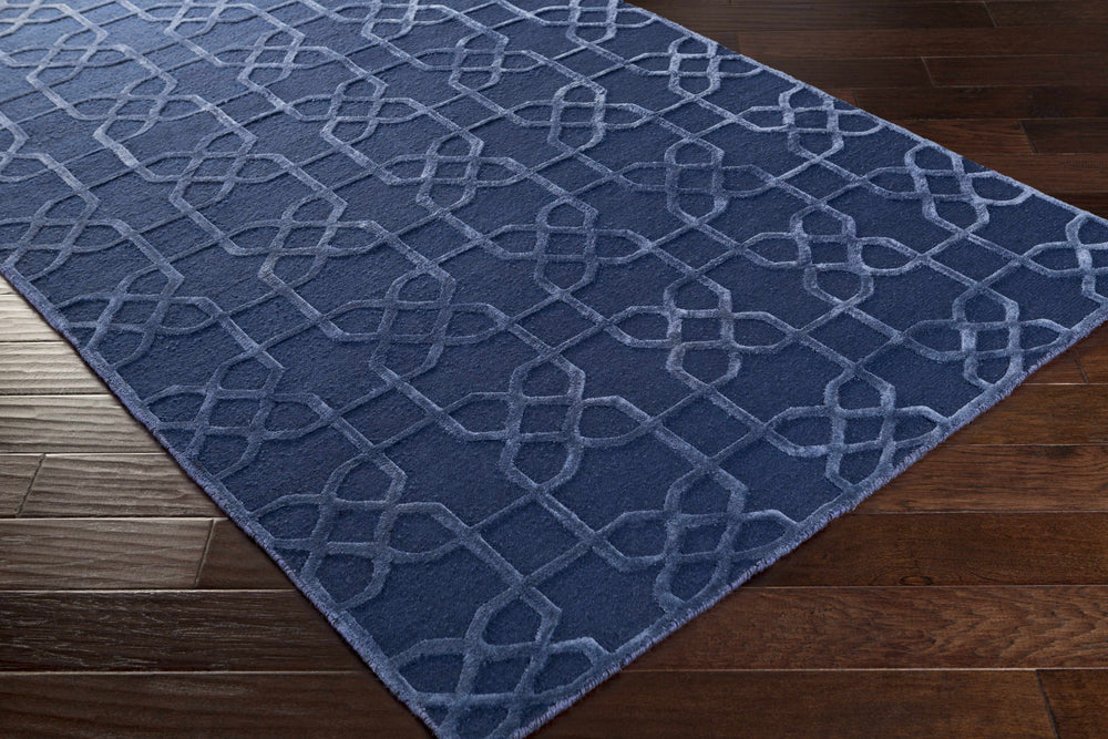 Blue geometric lattice wool carpet, hand-knotted, laid on hardwood floor.