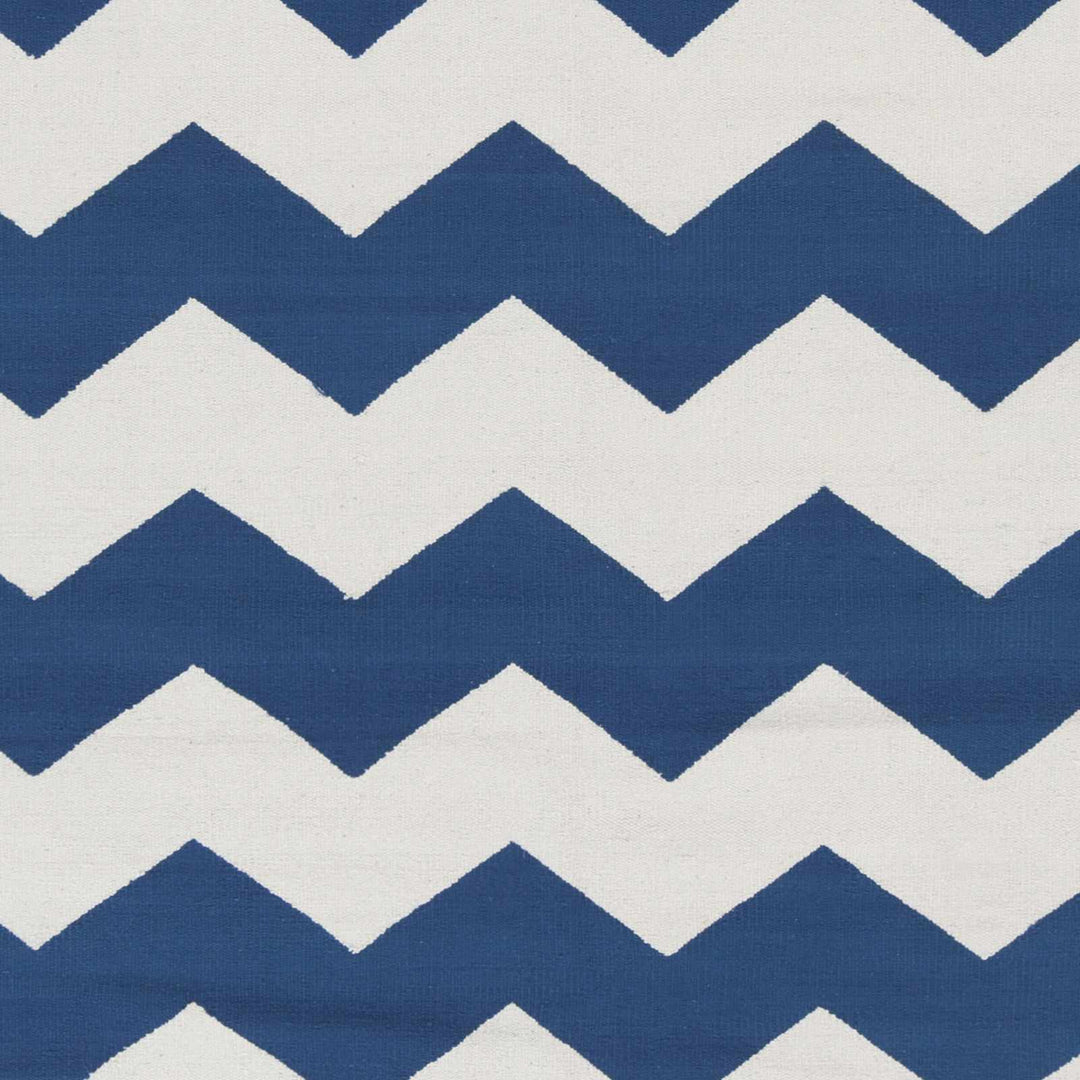 Hand-woven chevron rug close-up: blue and white zigzag woven pattern