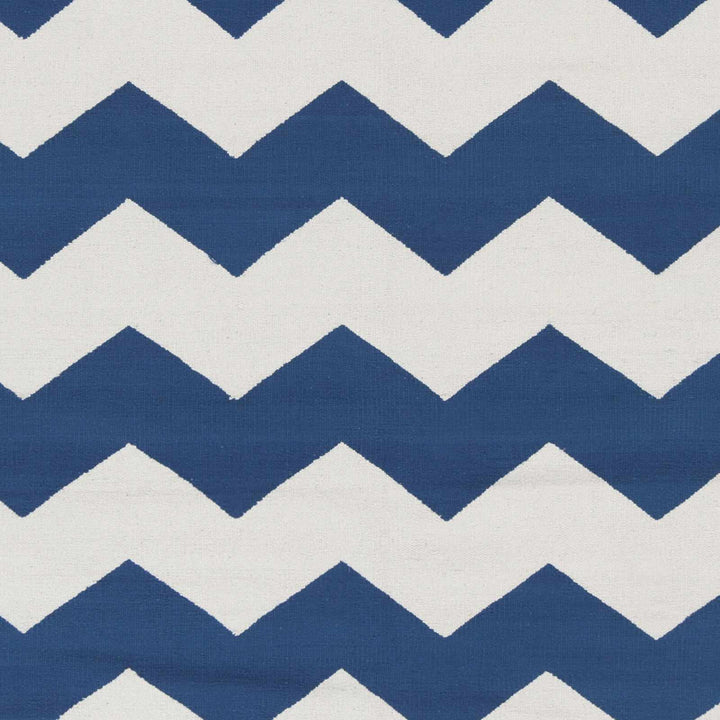 Hand-woven chevron rug close-up: blue and white zigzag woven pattern