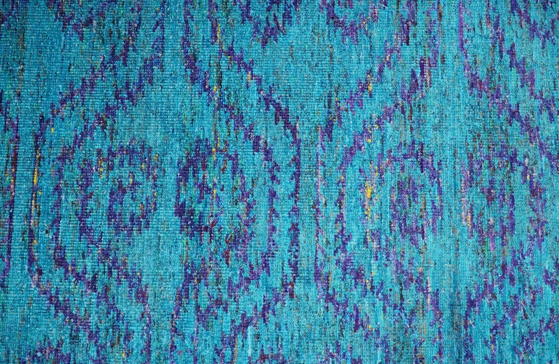 https://therugdecor.com/cdn/shop/products/8x10-and-9x12-hand-knotted-teal-blue-and-violet-modern-contemporary-southwestern-tribal-trellis-recycled-silk-area-rug-op10-734745_800x.jpg?v=1649506231